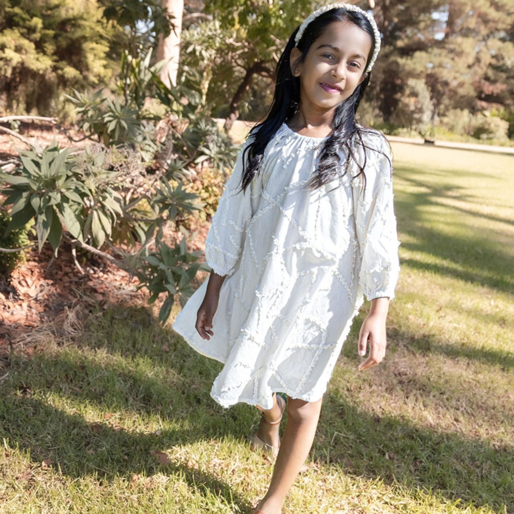Girl outdoors wearing Cream Cotton embroidery dress