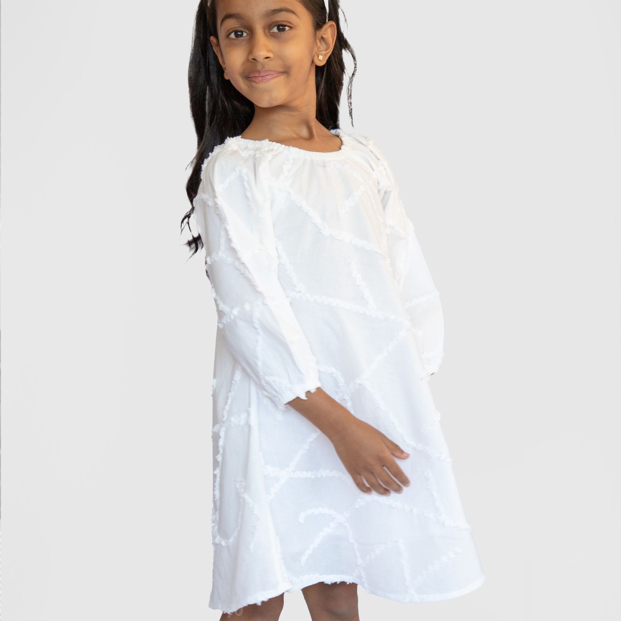 Child wearing white embroidery dress in cotton